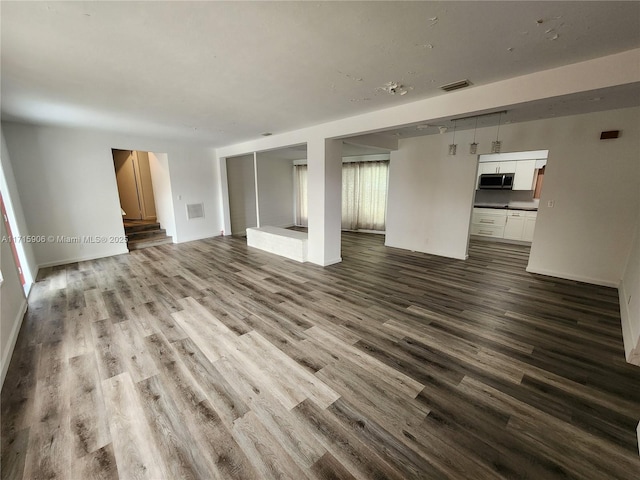 unfurnished living room featuring wood-type flooring