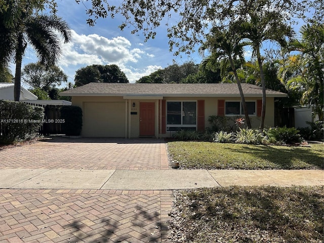 830 SW 18th St, Fort Lauderdale, FL 33315 - ranch-style house with a garage, decorative driveway, and a front yard