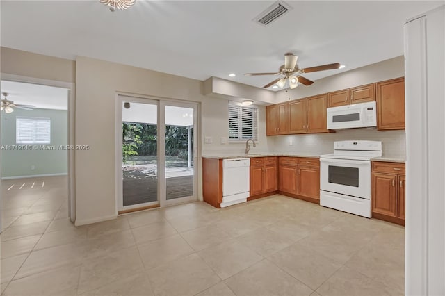 kitchen with light tile patterned floors, white appliances, ceiling fan, and sink