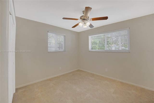 empty room with a wealth of natural light and ceiling fan