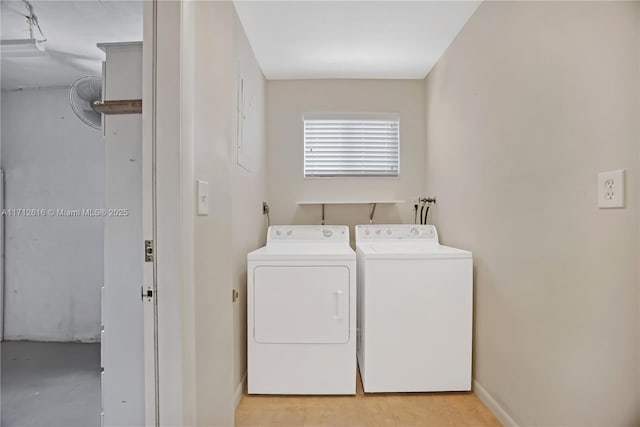 clothes washing area with separate washer and dryer