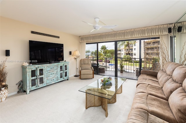 carpeted living room with ceiling fan