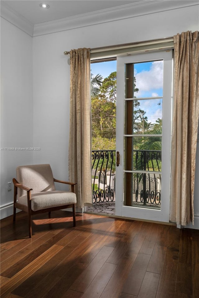 sitting room featuring wood finished floors and crown molding