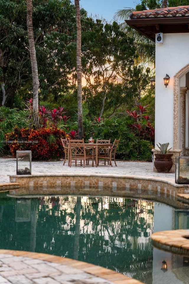 pool featuring outdoor dining area and a patio area