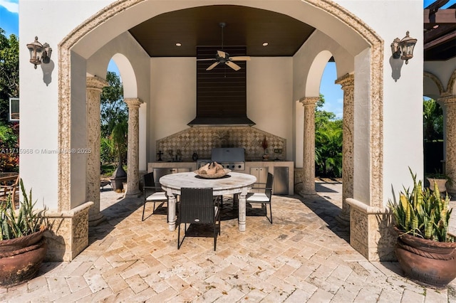 view of patio / terrace with grilling area, ceiling fan, and an outdoor kitchen