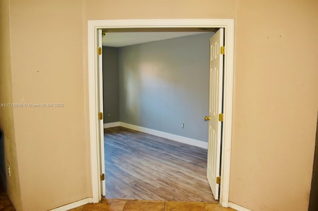 hallway with light hardwood / wood-style floors