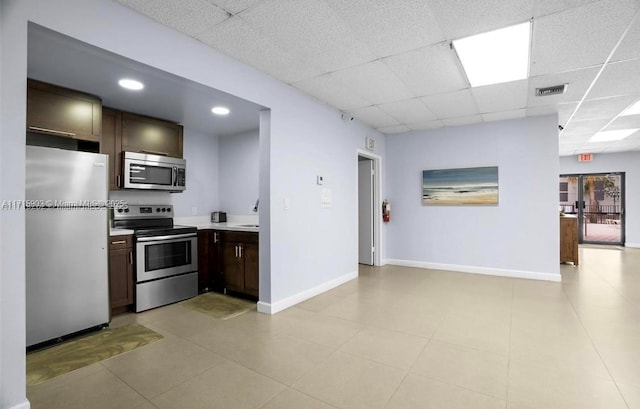 kitchen with a drop ceiling, dark brown cabinetry, sink, and appliances with stainless steel finishes