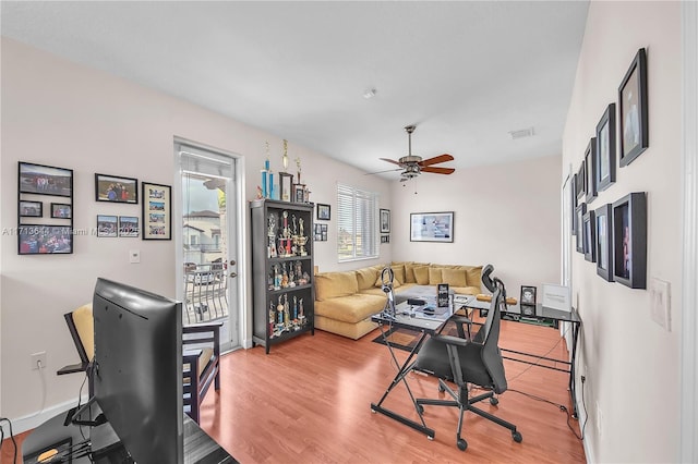 interior space featuring light wood-type flooring, visible vents, and ceiling fan