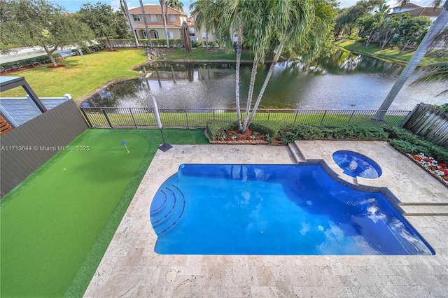 view of swimming pool featuring an in ground hot tub, a water view, and a lawn