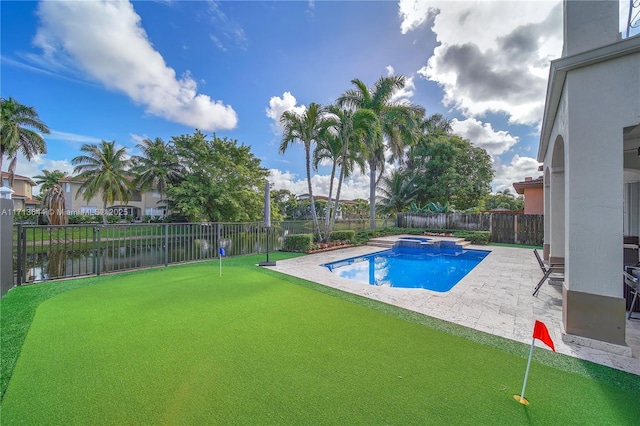view of swimming pool with a fenced backyard, a patio area, and a pool with connected hot tub