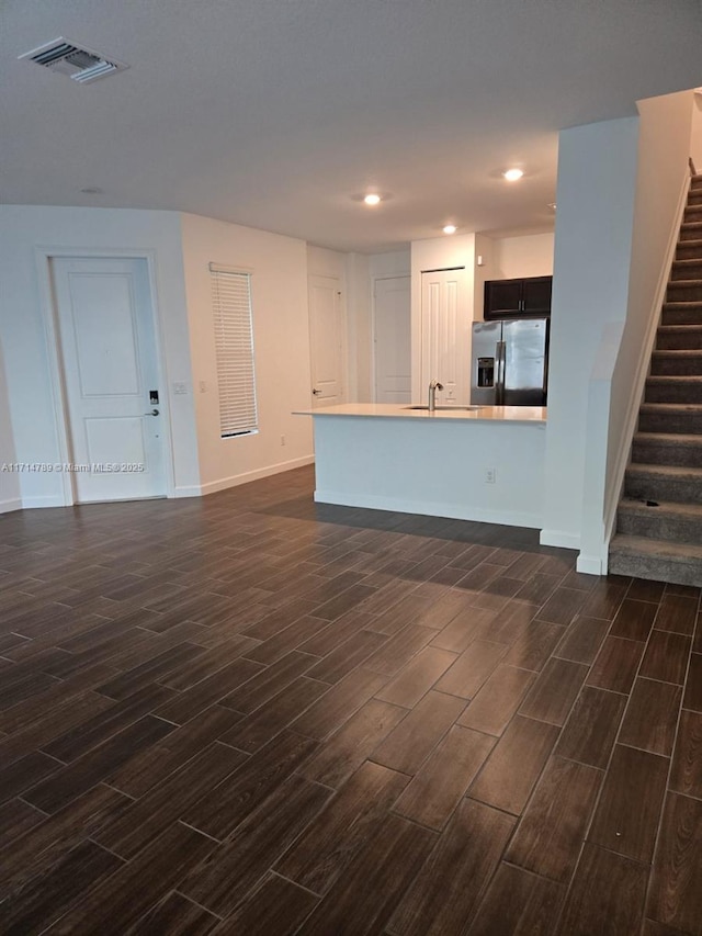 unfurnished living room featuring sink