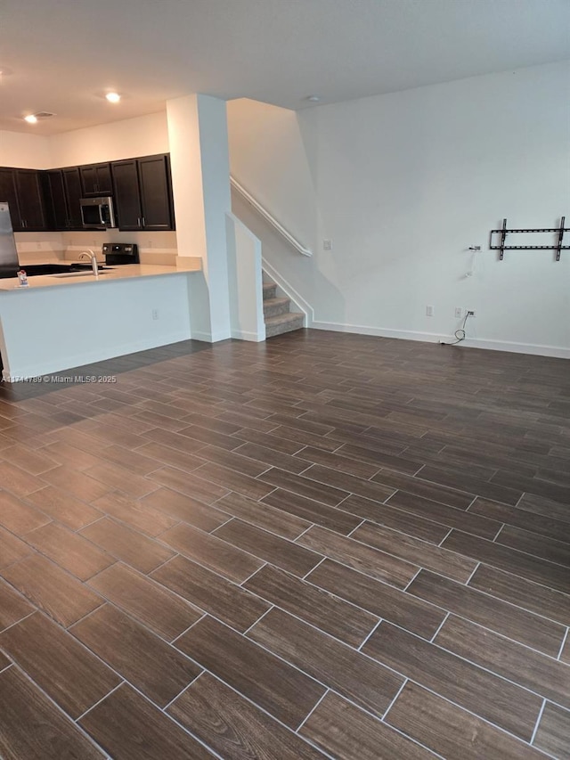 unfurnished living room featuring sink