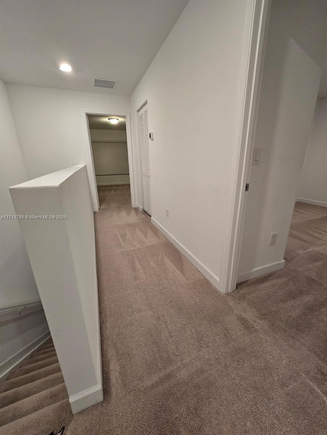 hallway with carpet floors