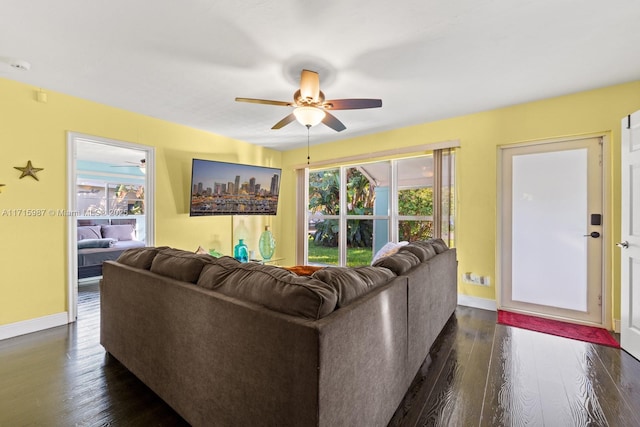 living room with dark hardwood / wood-style floors and ceiling fan