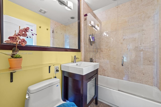 full bathroom with shower / bath combination with glass door, vanity, and toilet