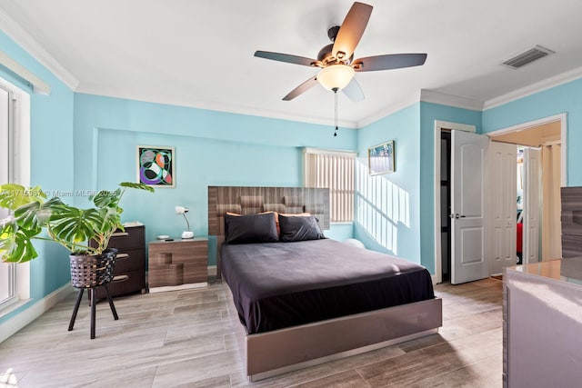 bedroom with ceiling fan and crown molding