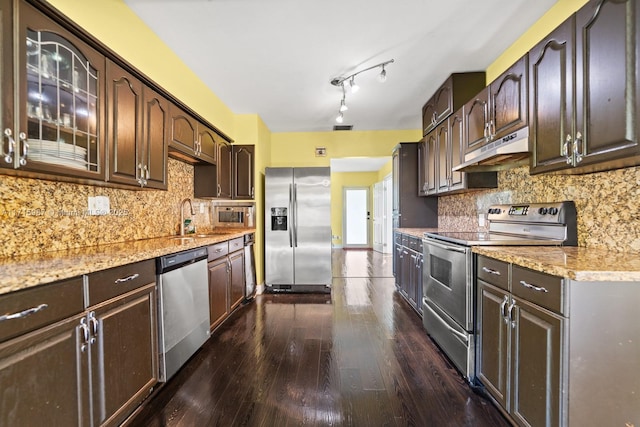 kitchen featuring dark brown cabinets, decorative backsplash, sink, and appliances with stainless steel finishes