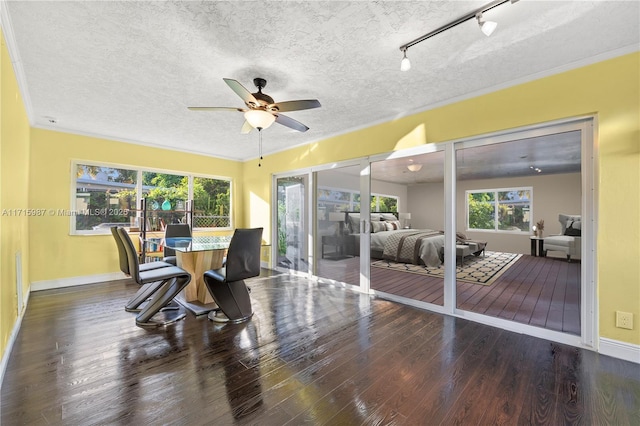 dining area featuring ornamental molding, ceiling fan, and dark wood-type flooring