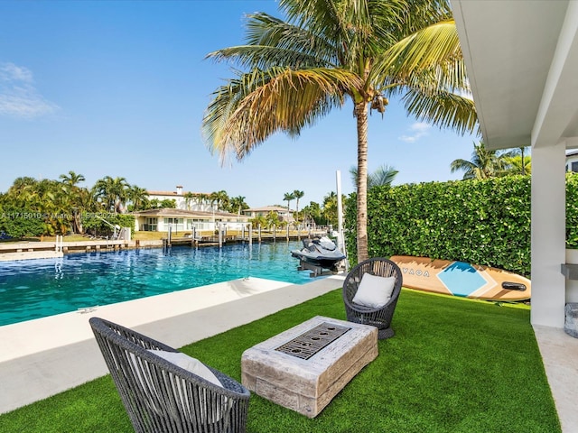 view of pool with a dock, a yard, and a water view