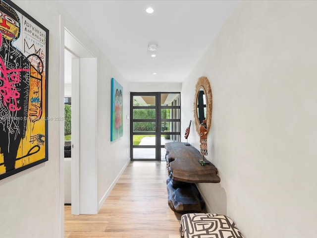 hall featuring light hardwood / wood-style flooring and french doors