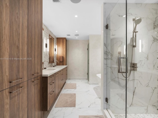 bathroom with vanity and a shower with shower door