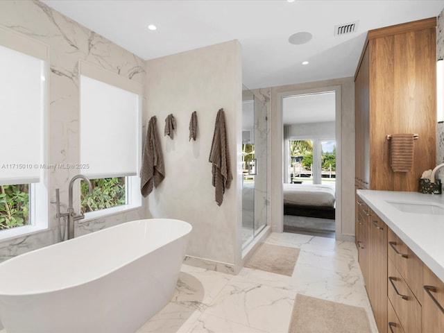 bathroom with vanity, separate shower and tub, and plenty of natural light