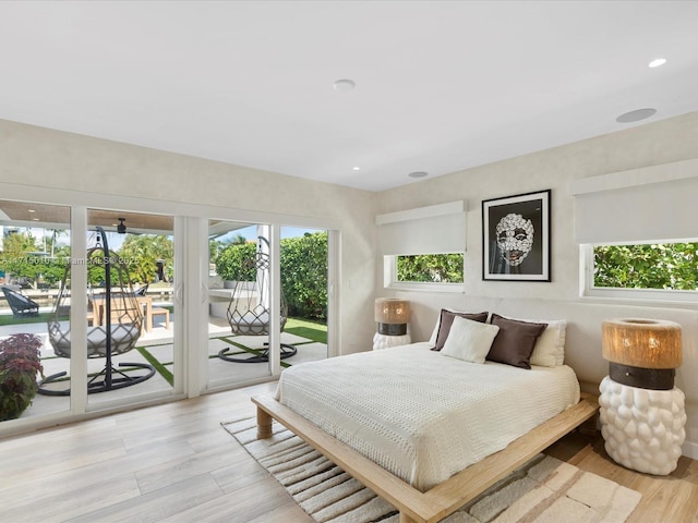 bedroom with access to outside and light hardwood / wood-style floors