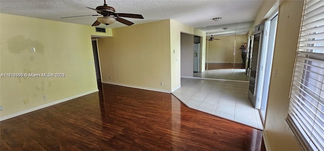 251 SW 132nd Unit 417H, Pembroke Pines, FL 33027 - spare room featuring a ceiling fan, wood finished floors, a textured ceiling, and healthy amount of natural light