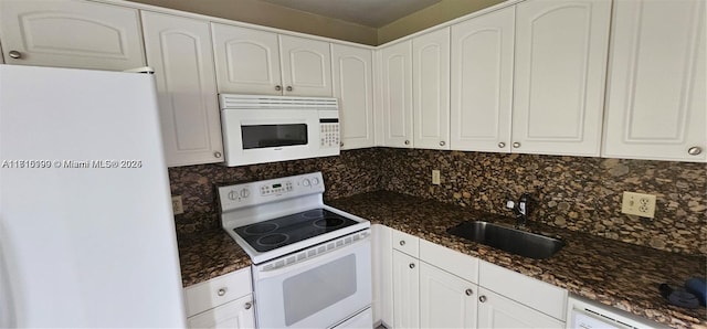 kitchen with white cabinets, white appliances, and tasteful backsplash