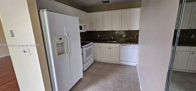 kitchen featuring white cabinetry, sink, backsplash, white appliances, and light tile patterned flooring