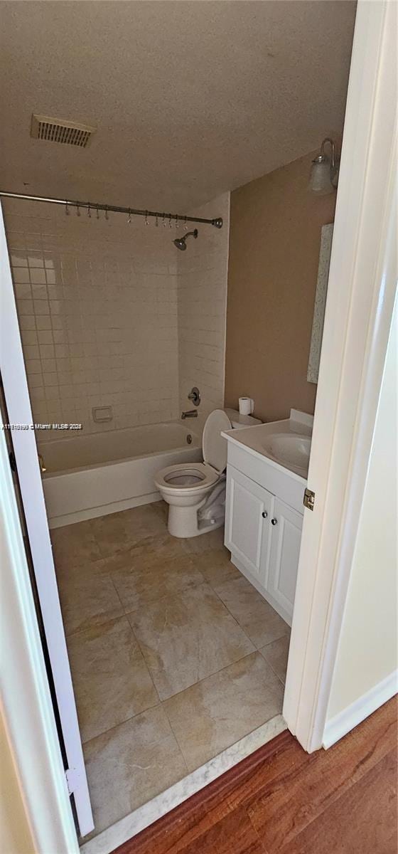 251 SW 132nd Unit 417H, Pembroke Pines, FL 33027 - bathroom featuring shower / bathtub combination, vanity, and a textured ceiling