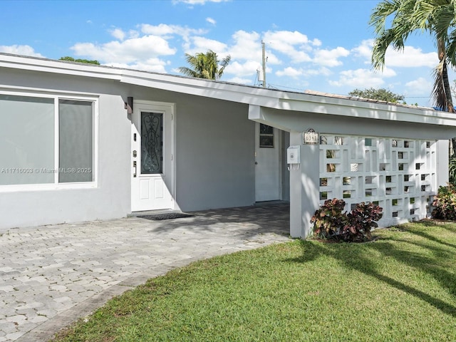 exterior space featuring a lawn and a carport