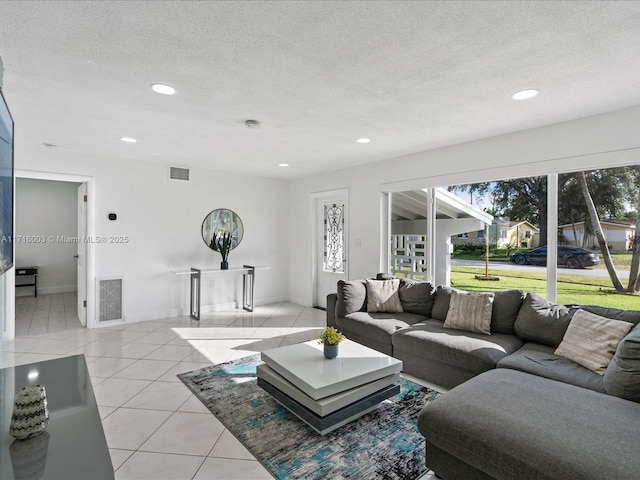 living room featuring a textured ceiling and light tile patterned flooring