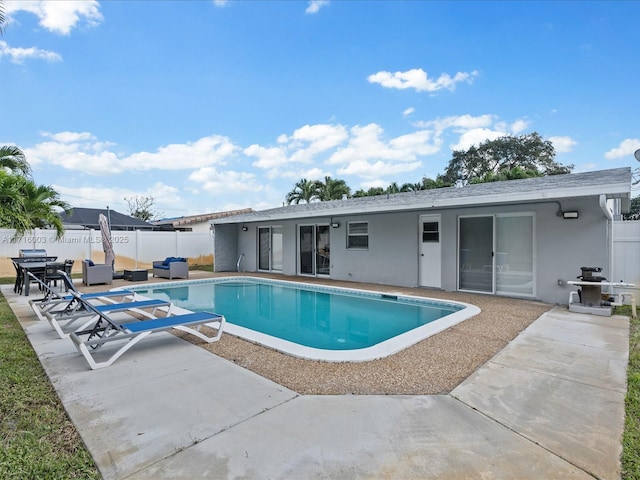 view of swimming pool with an outdoor living space and a patio area