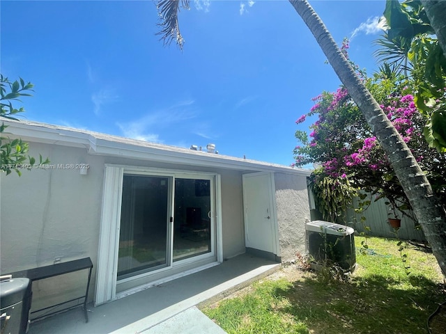 view of side of property with central AC unit