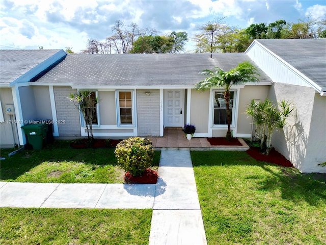 ranch-style home with a front lawn