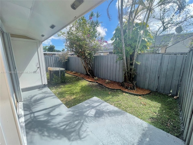 view of yard with central air condition unit and a patio area