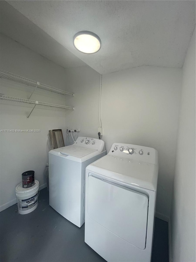 clothes washing area featuring independent washer and dryer and a textured ceiling