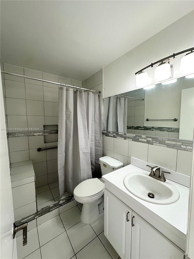 bathroom with toilet, a shower with curtain, tasteful backsplash, tile walls, and vanity