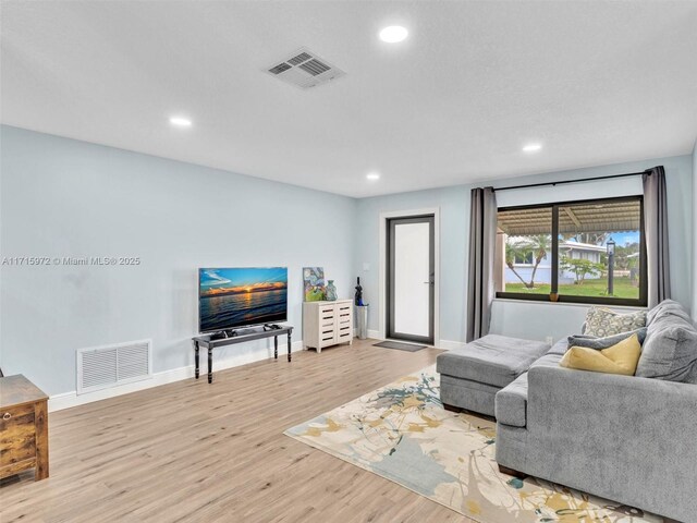 6708 NW 58th Ct, Tamarac, FL 33321 - living room featuring light hardwood / wood-style floors