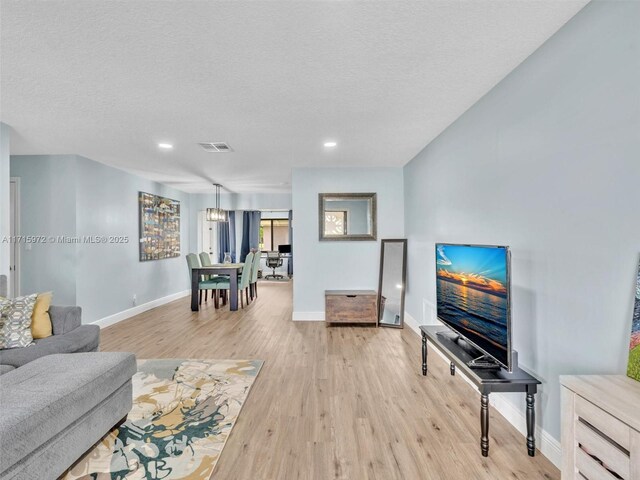 6708 NW 58th Ct, Tamarac, FL 33321 - living room featuring light wood-type flooring and a textured ceiling