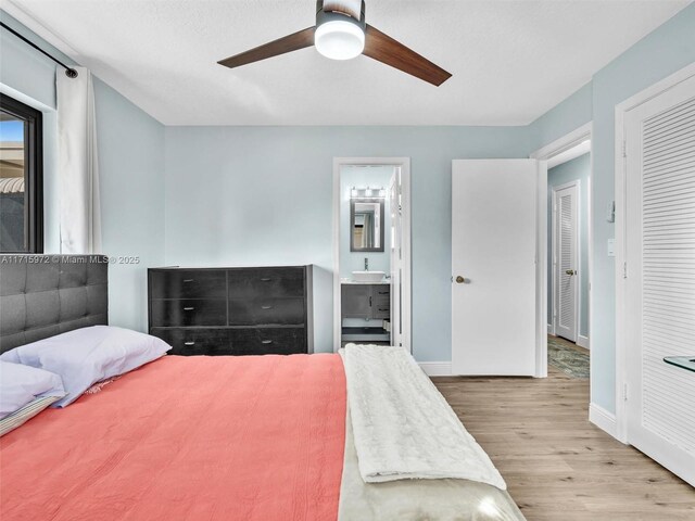 6708 NW 58th Ct, Tamarac, FL 33321 - bedroom featuring ceiling fan, sink, light wood-type flooring, and ensuite bathroom