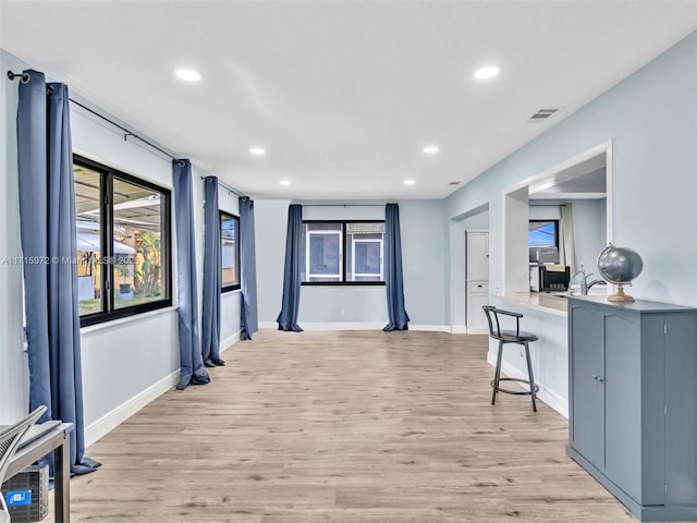 corridor with light hardwood / wood-style floors