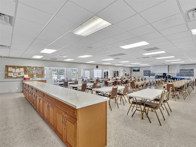 kitchen with a drop ceiling and a kitchen island