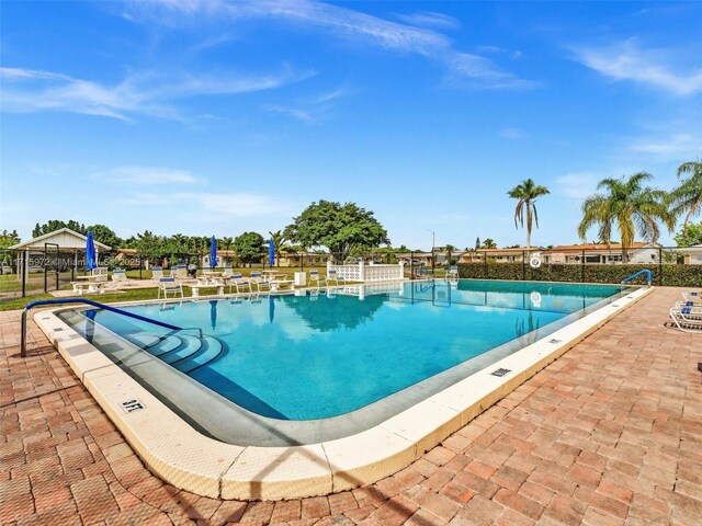 6708 NW 58th Ct, Tamarac, FL 33321 - view of swimming pool with a patio area