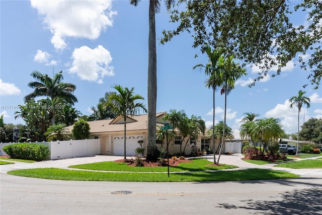 single story home with a front yard and a garage