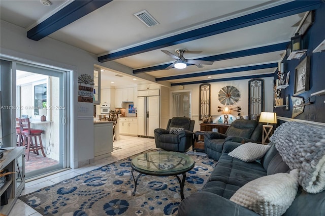 living room with beamed ceiling, light tile patterned floors, and ceiling fan