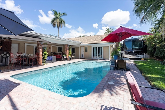 view of pool with outdoor lounge area and a patio