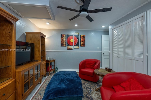 sitting room featuring crown molding and ceiling fan