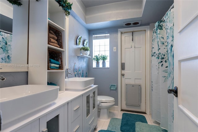 bathroom featuring toilet, vanity, and tile patterned floors